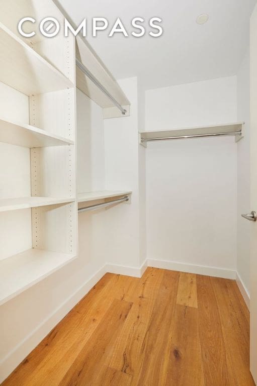 spacious closet with wood finished floors