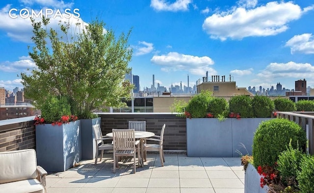 view of patio featuring a city view and outdoor dining space