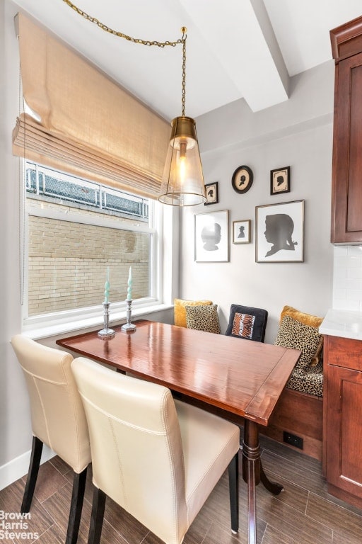 dining area featuring breakfast area and beamed ceiling