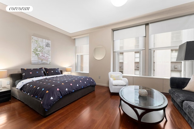 bedroom featuring baseboards, visible vents, and dark wood finished floors