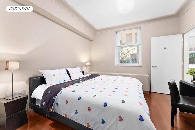 bedroom featuring visible vents and dark wood finished floors