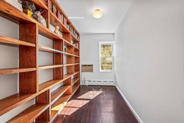 storage area with a wall mounted air conditioner and baseboard heating