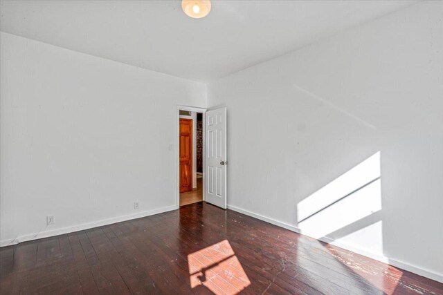 empty room featuring dark wood-type flooring