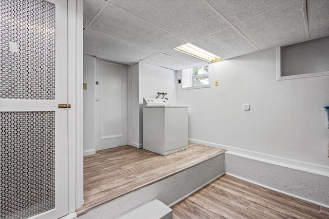 interior space with wood-type flooring and washer / dryer