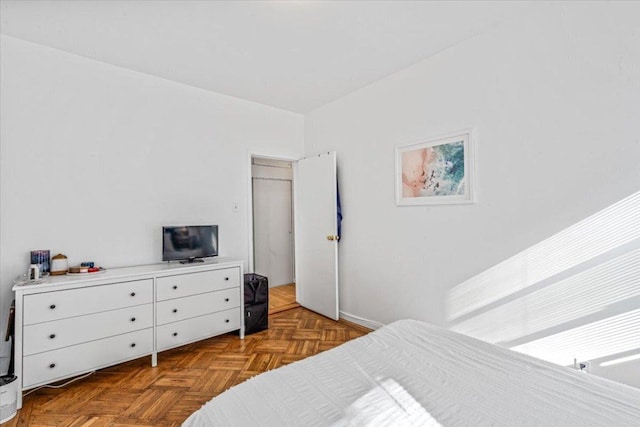 bedroom with dark parquet flooring