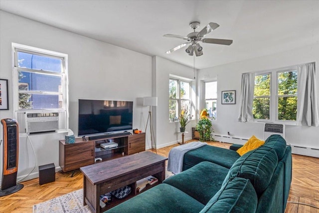 living room featuring cooling unit, ceiling fan, a baseboard heating unit, and light parquet flooring