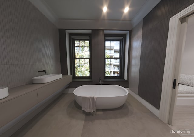 bathroom with a freestanding tub and baseboards