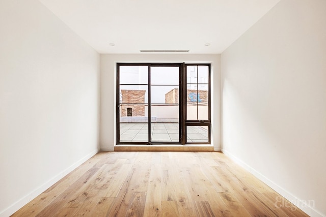 spare room featuring light wood-type flooring