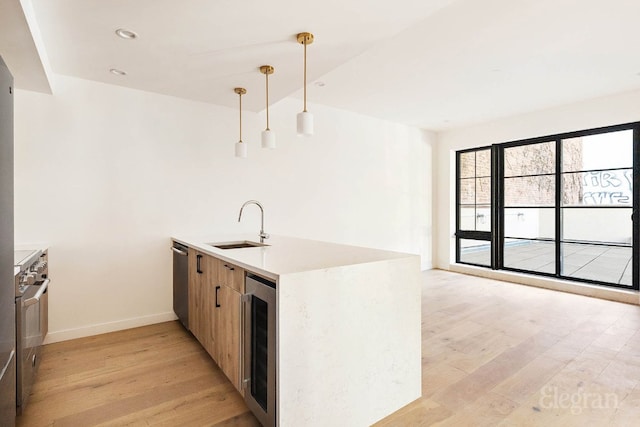 kitchen featuring kitchen peninsula, beverage cooler, dishwasher, pendant lighting, and sink