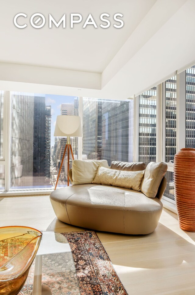 135 W 52nd St Unit 23C, New York City, NY 10019 - living room featuring a city view and wood finished floors