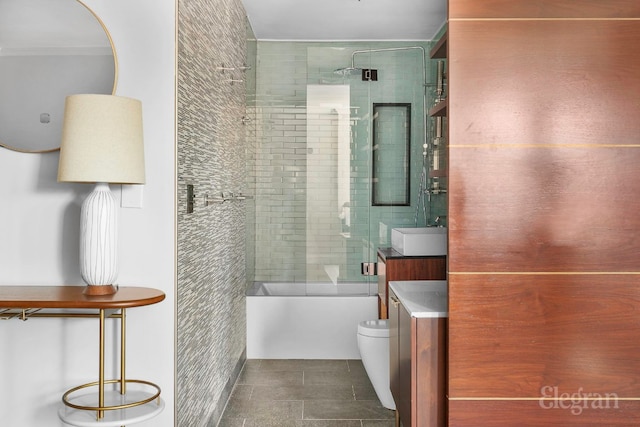 full bathroom featuring vanity, combined bath / shower with glass door, and toilet