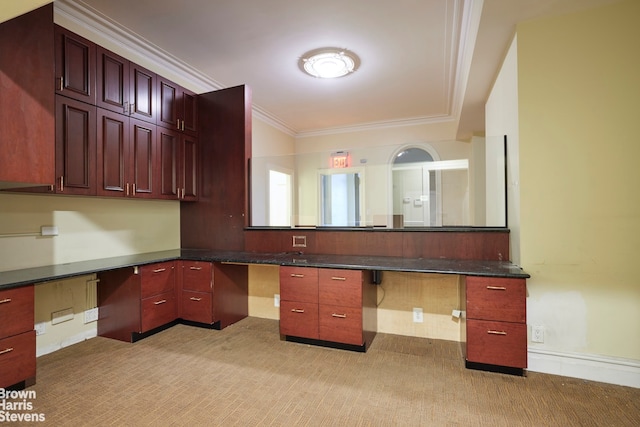 interior space featuring ornamental molding and built in desk