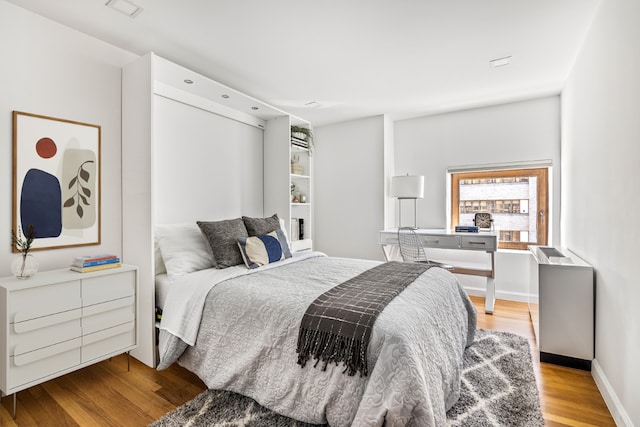 bedroom with light hardwood / wood-style flooring