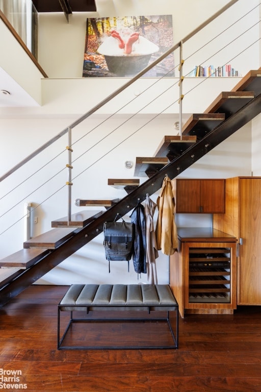 stairway featuring wine cooler and hardwood / wood-style flooring