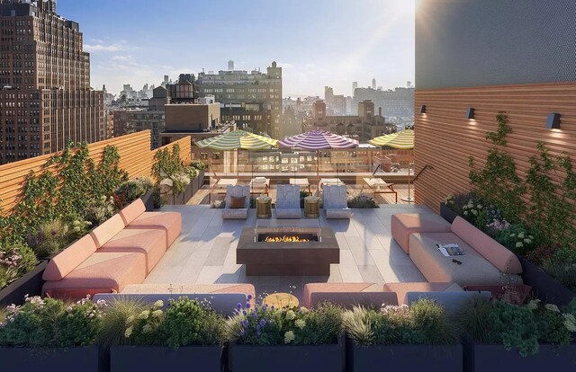 view of patio with a view of city and an outdoor living space with a fire pit
