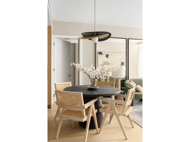 dining space with wood finished floors
