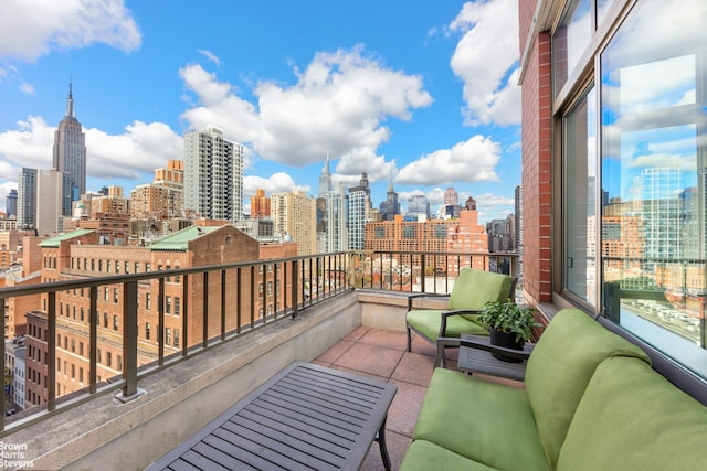 balcony featuring an outdoor living space and a city view