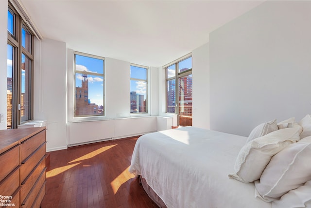 bedroom with dark wood-style flooring