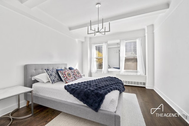 bedroom with dark wood-type flooring, baseboards, and an inviting chandelier