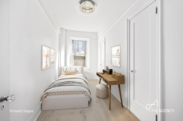 bedroom with light wood-style floors and baseboards