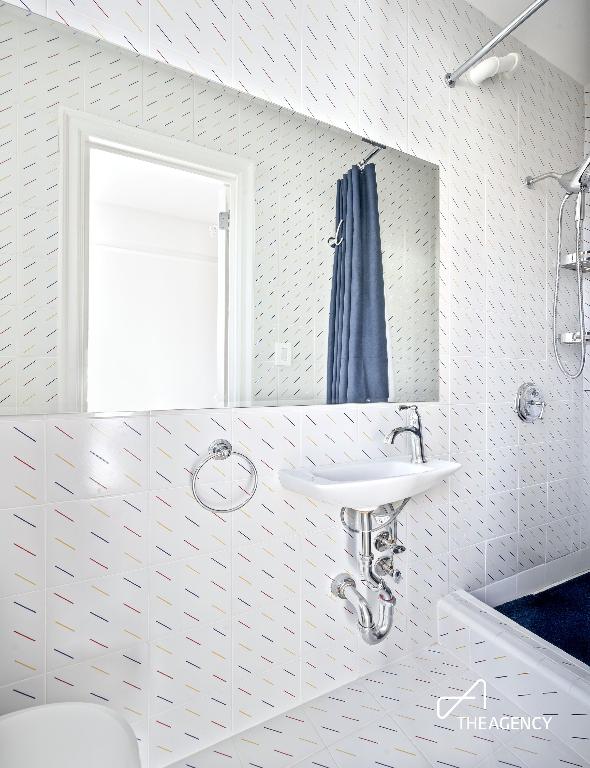 interior space with a sink and a shower stall