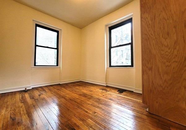 spare room with hardwood / wood-style floors and a wealth of natural light