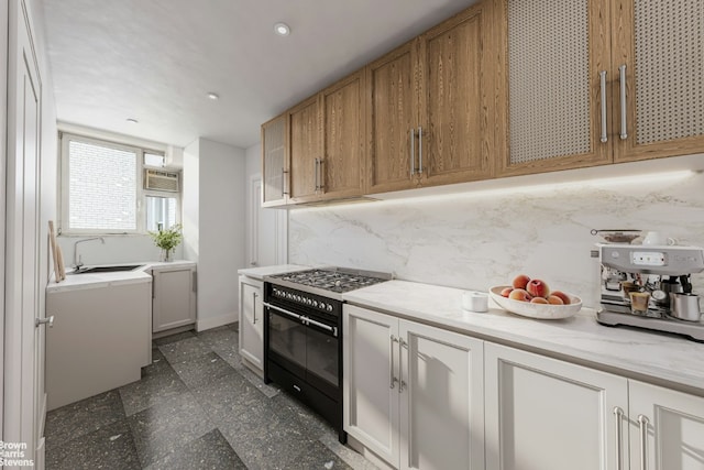 kitchen featuring sink, range with two ovens, backsplash, and oven