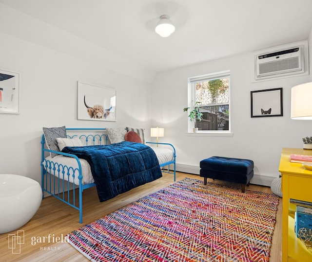 137 Bay Ridge Pkwy Unit 1, New York City, NY 11209 - bedroom featuring wood finished floors and a wall mounted air conditioner