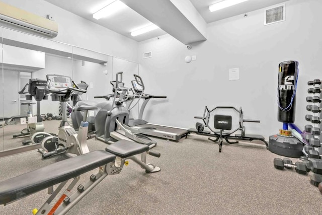 workout area featuring a wall mounted air conditioner