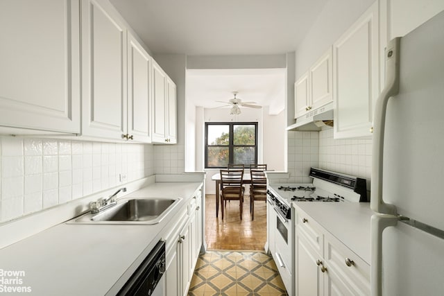 kitchen featuring white appliances, under cabinet range hood, white cabinetry, and a sink