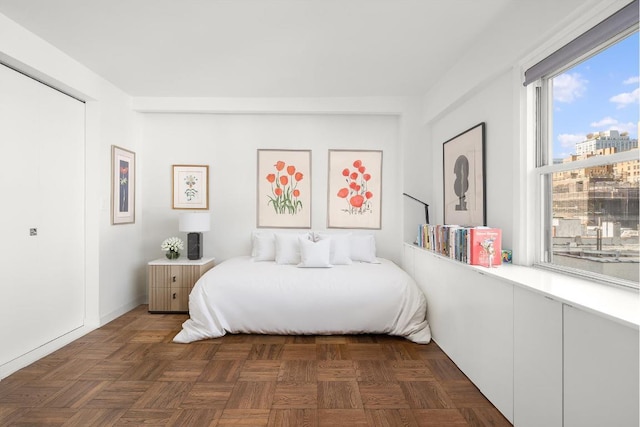 bedroom featuring dark parquet floors