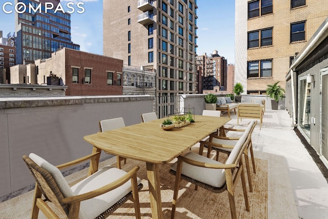 view of patio featuring an outdoor hangout area and a balcony