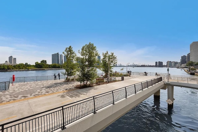 view of dock with a view of city and a water view