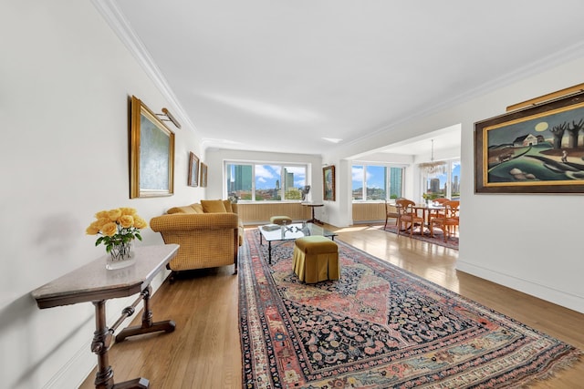 living area with crown molding, baseboards, and wood finished floors