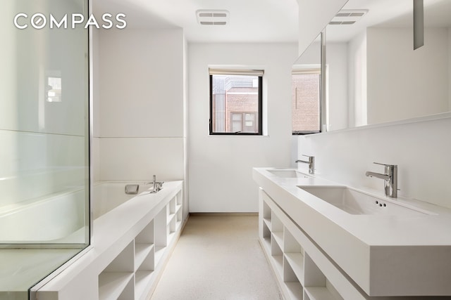 100 11th Ave Unit 7D, New York City, NY 10011 - bathroom featuring double vanity, baseboards, and a tub to relax in
