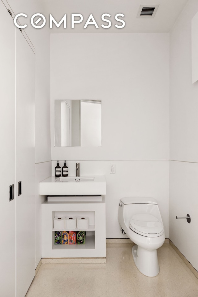 100 11th Ave Unit 7D, New York City, NY 10011 - bathroom featuring toilet, vanity, and baseboards