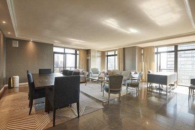 dining space featuring a tray ceiling and a wall of windows