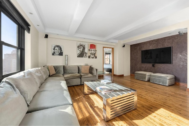 living room featuring beamed ceiling and hardwood / wood-style flooring