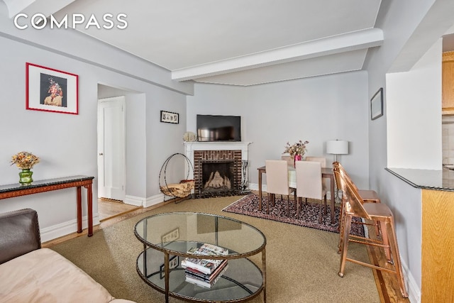 living room with a fireplace and beam ceiling