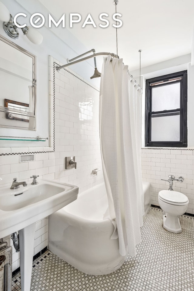 bathroom featuring toilet, tile walls, and tile patterned flooring