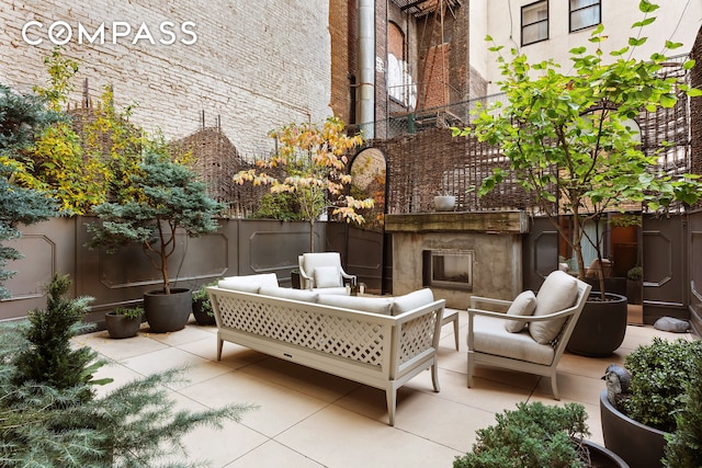 view of patio with an outdoor living space with a fireplace