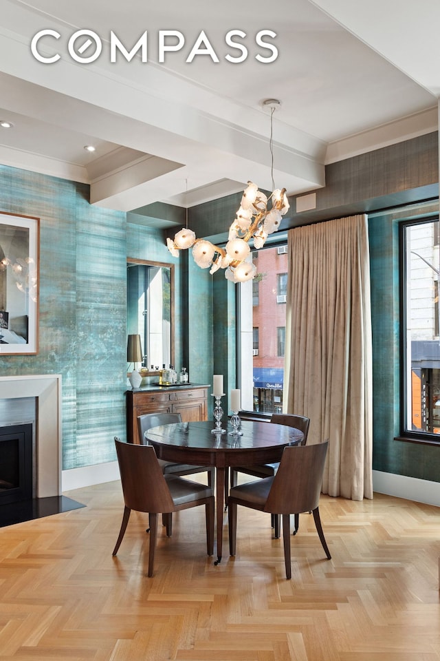 dining room featuring wallpapered walls, baseboards, beamed ceiling, ornamental molding, and a fireplace