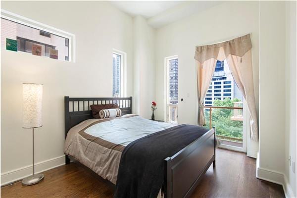 bedroom featuring dark wood-type flooring and baseboards