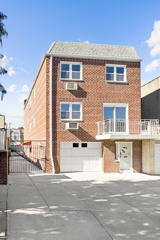 view of front of property with a garage and a balcony