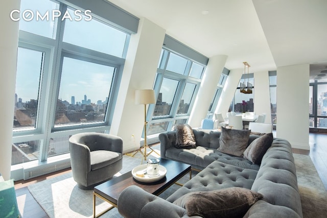 living area featuring baseboards, a view of city, visible vents, and wood finished floors