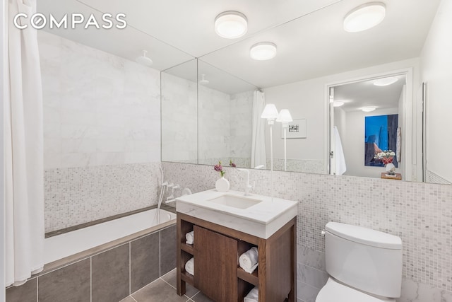 full bath with tile walls, tiled shower, vanity, tiled tub, and toilet