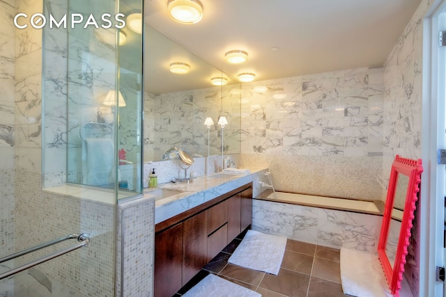 bathroom featuring tile walls, tile patterned flooring, and double vanity