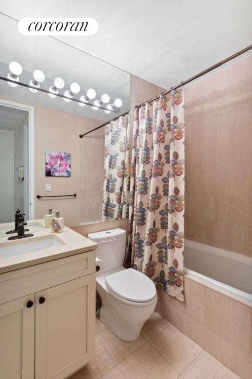 full bathroom featuring tile patterned floors, toilet, vanity, and shower / tub combo