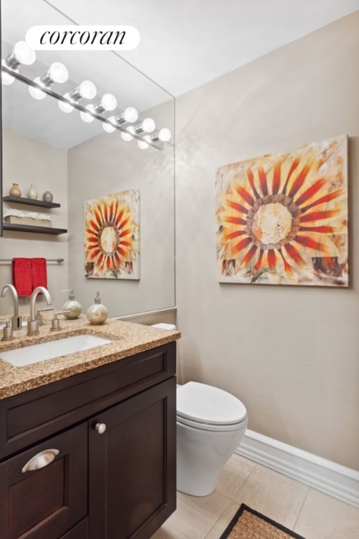 bathroom with toilet, tile patterned flooring, and vanity