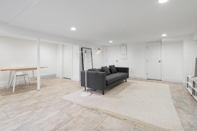 living area with baseboards and recessed lighting